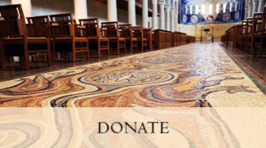 closeup of mosaic processional floor with 'donate' banner below