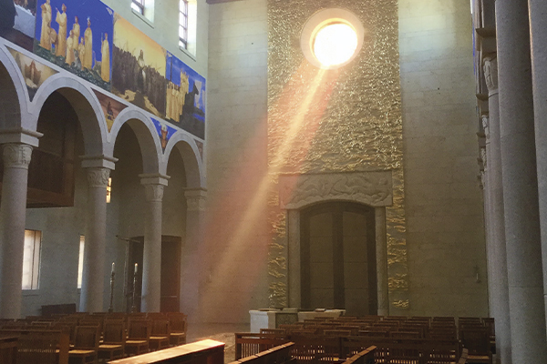 light shining through stained glass oculus window